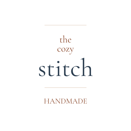 Text 'the cozy stitch HANDMADE' on a white background